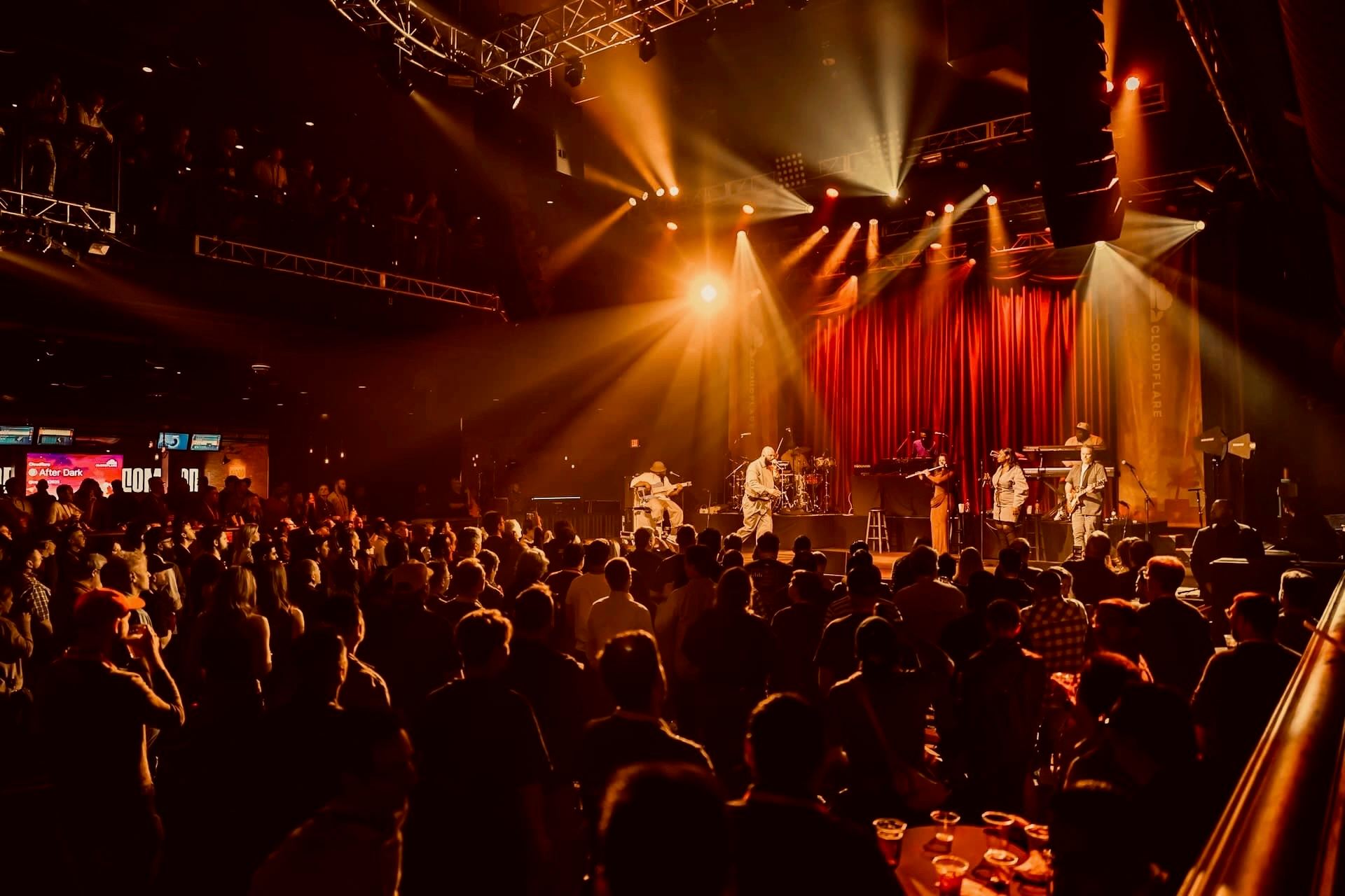 Crowd enjoying a live concert at a Cloudflare after-party